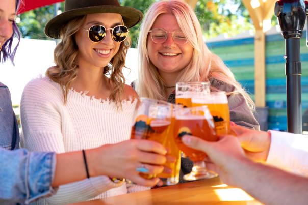 Friends cheering beers on the patio at Blackrocks Brewery