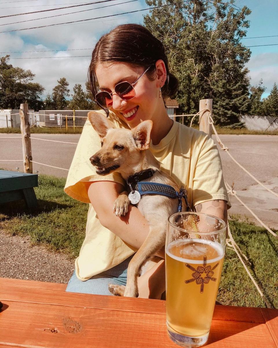 A woman and her pup enjoying the patio at Drifia Brewery