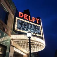 Delft bistro's marquee lit up in the evening in downtown Marquette