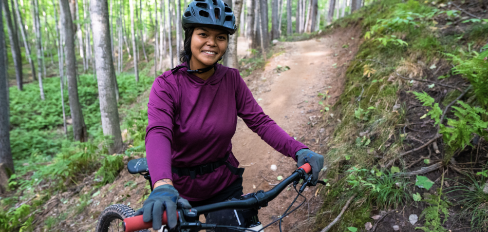 A lady on a mountain bike stop on a trail