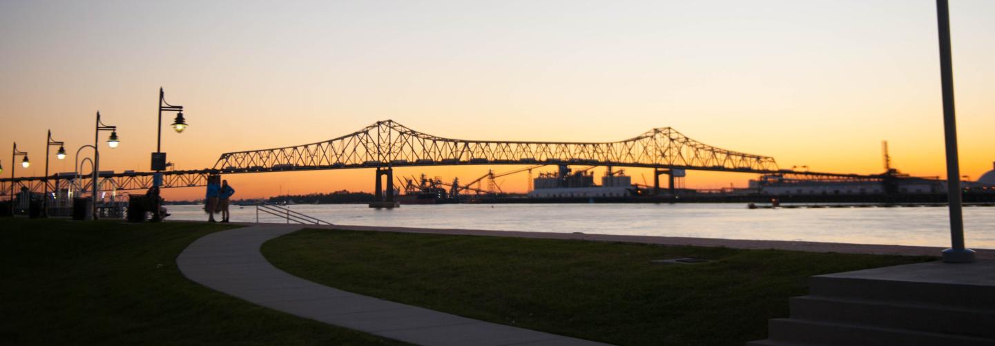 Visitors admore the sun as it sets just past the Horace Wilkinson Bridge in Baton Rouge.
