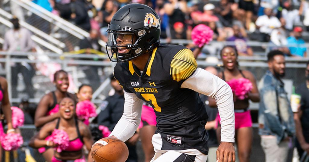 A Bowie State football player runs with the ball in a game