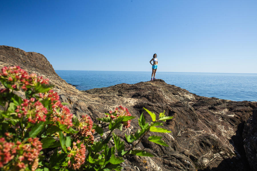 A woman posing on Black Rocks at Presque Isle Park