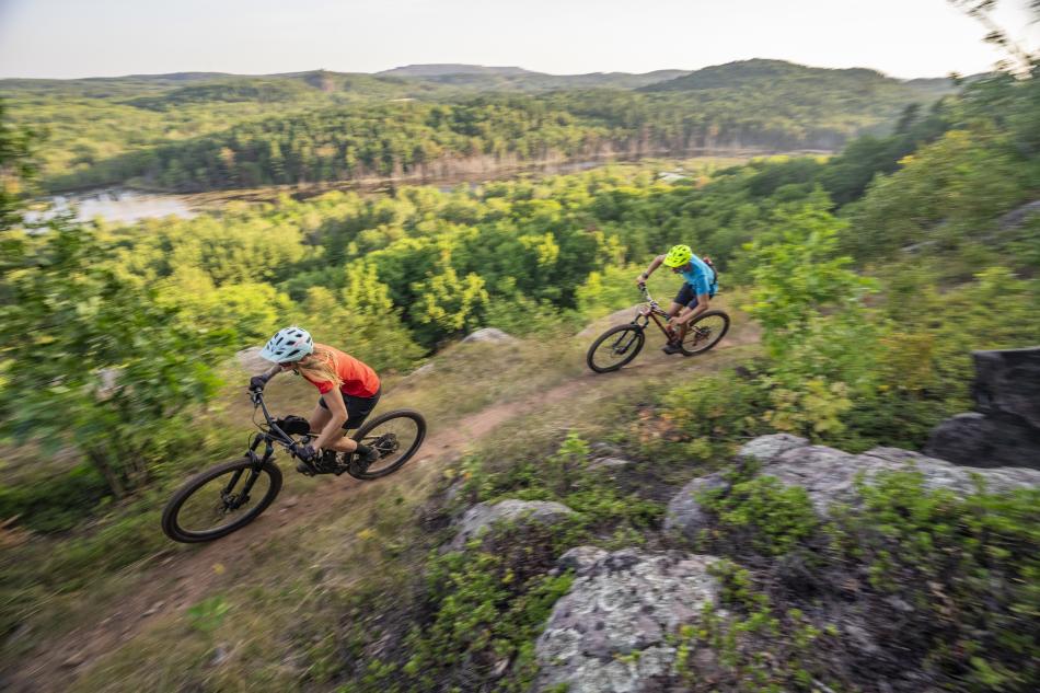 Two mountain bikers riding RAMBA's trails near Marquette, MI