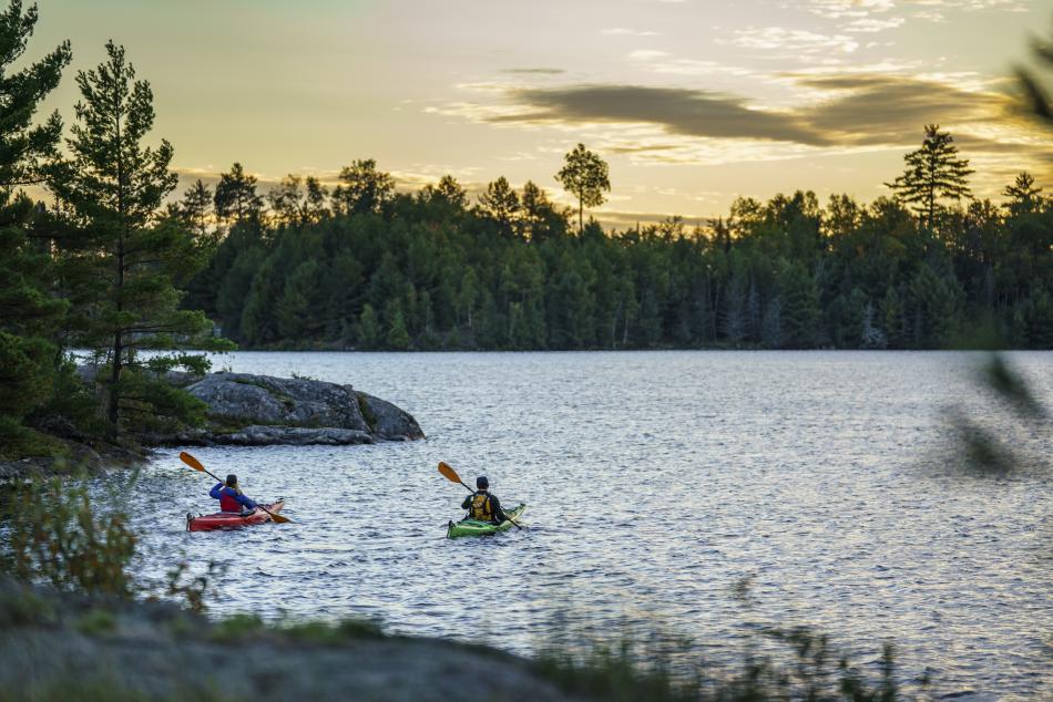 A couple kayaking on an inland lake in Marquette County, MI