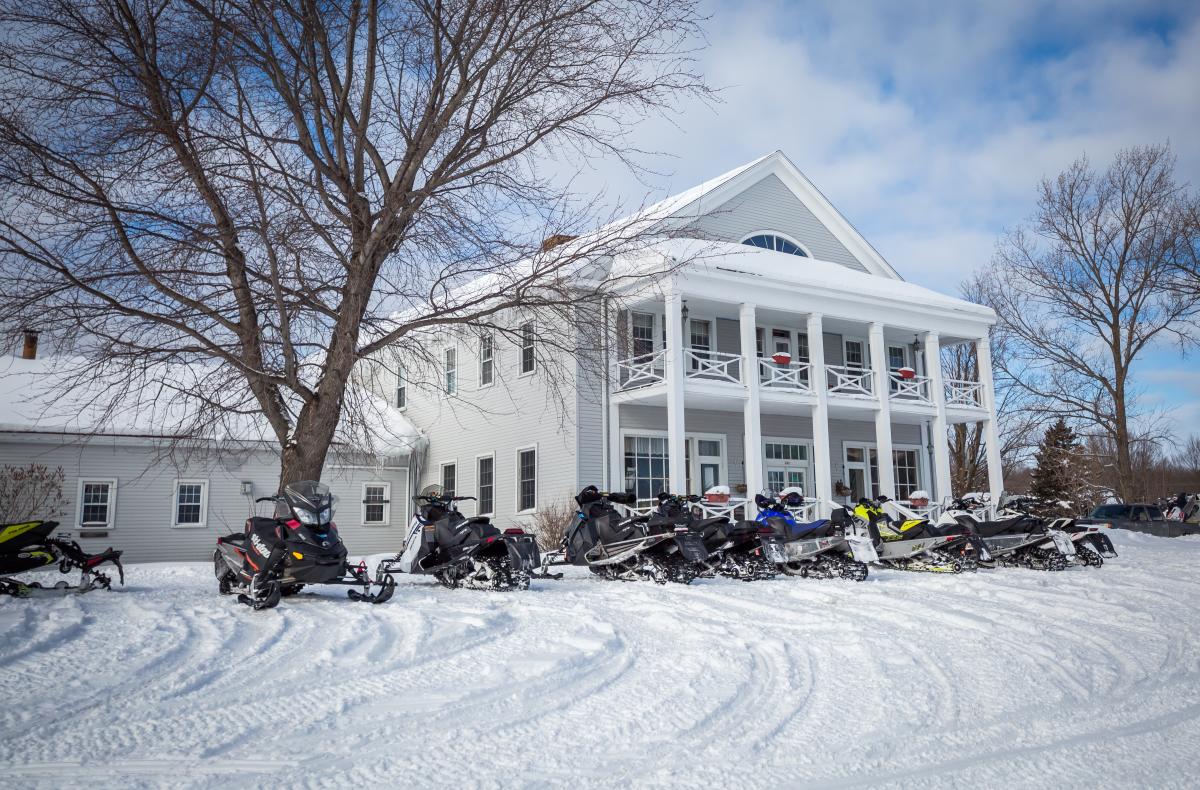 Snowmobiles lined up outside of Thunder Bay Inn in Big Bay, MI