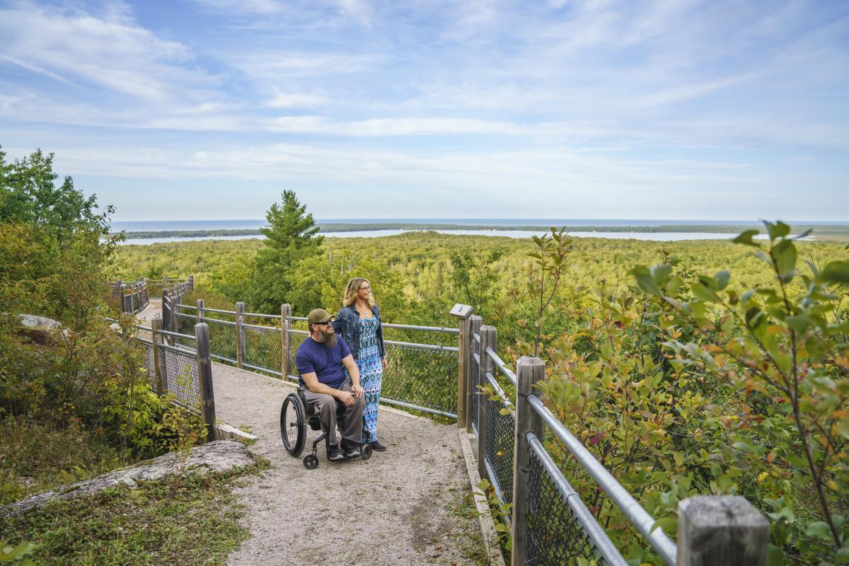 A couple looking out at Thomas Rock Scenic Overlook in Big Bay, MI