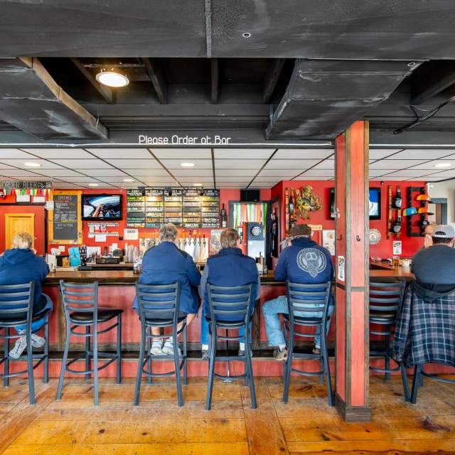 Men ordering at White Flame Brewery.