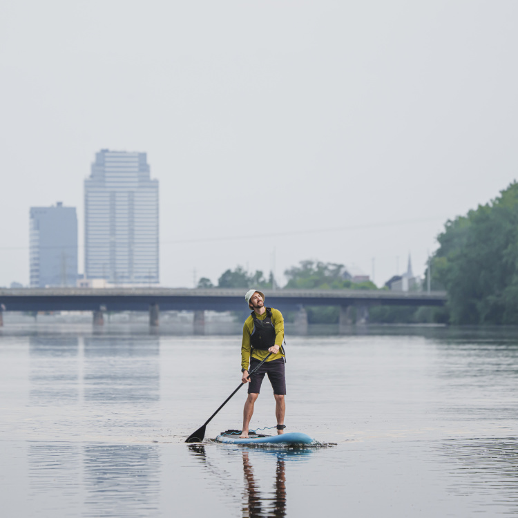 Paddle boarding on the Grand River with downtown Grand Rapids in the background.