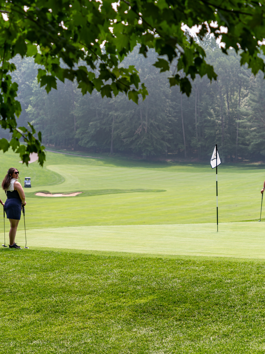 Golfers around a green