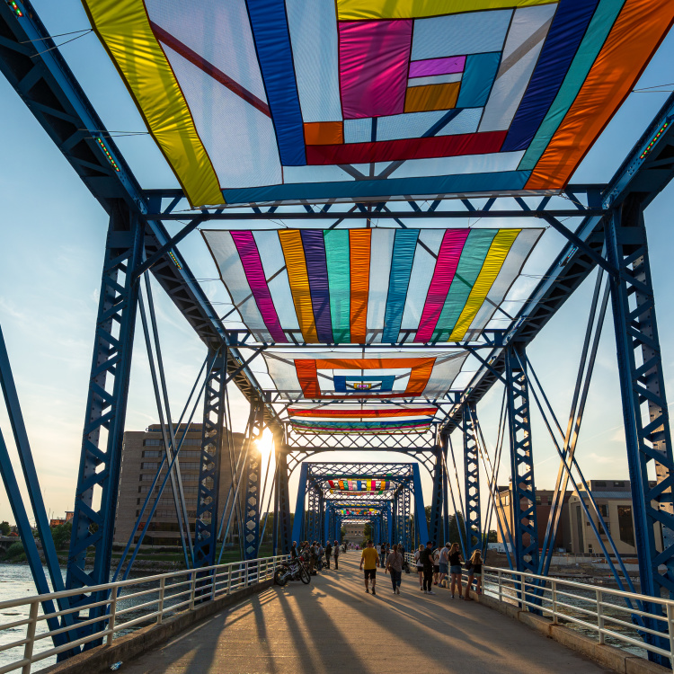 Colorful Sky by Day, Sky by Night fabric installation spanning the Blue Bridge during ArtPrize in Grand Rapids