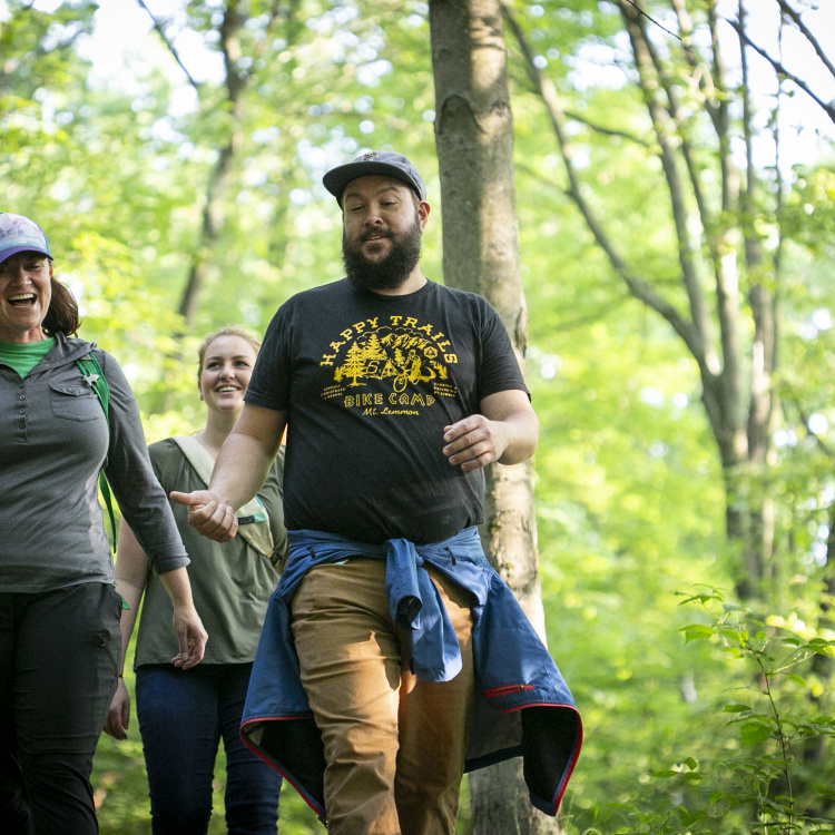 Friends hiking on the North Country Trail in the spring or fall.