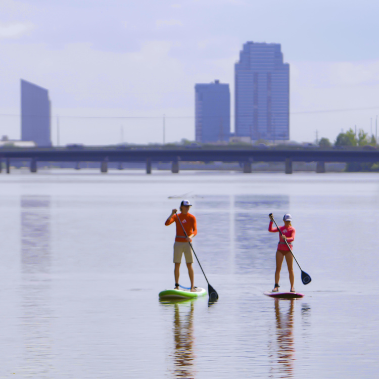 Stand up paddling towards downtown on the Grand River.