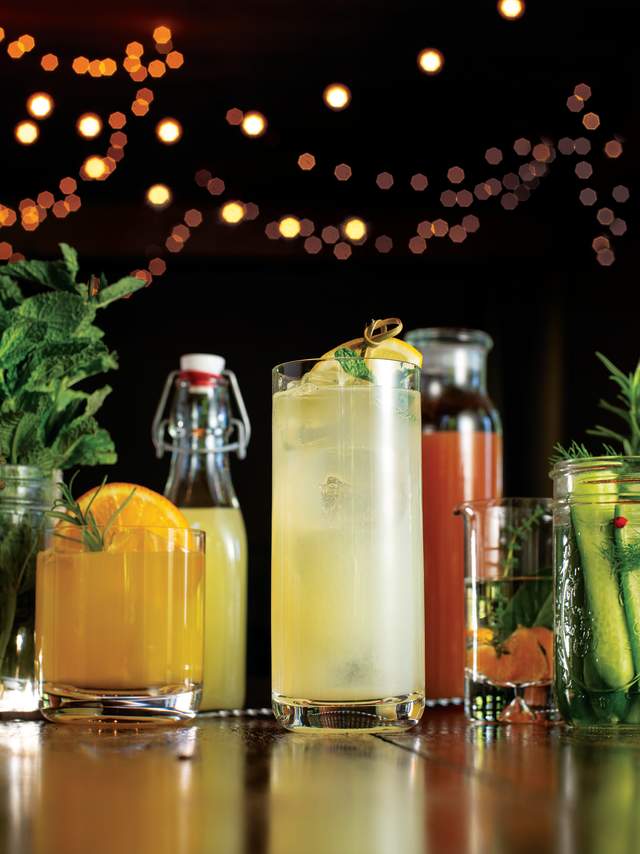String lights in the background of colorful craft drinks.