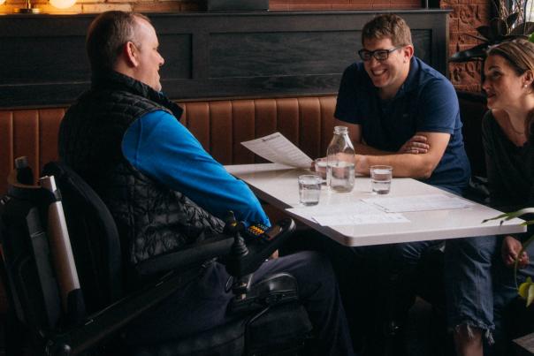 Group of three friends seated at a table at the Winchester, a restaurant in Grand Rapids.