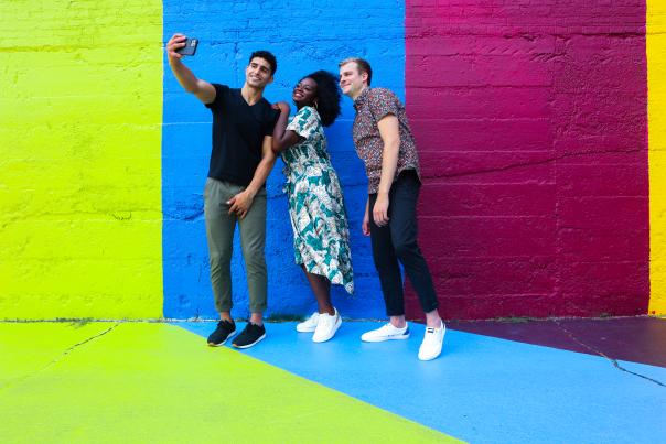 Group Photo in front of Mural at Lions & Rabbits Center for the Arts