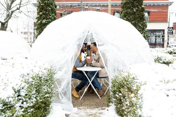 Couple in a cozy Dome in a winter setting.