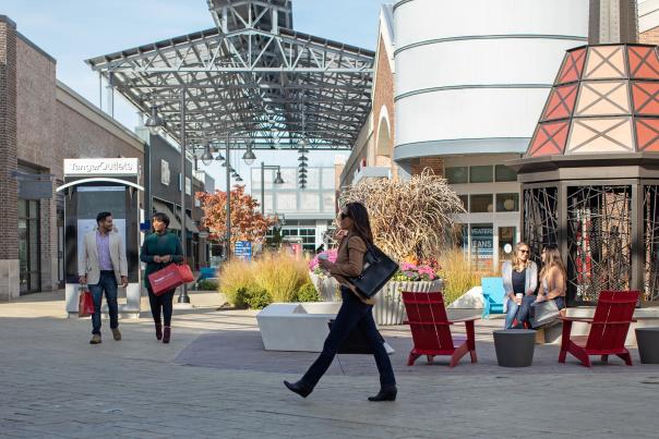 A group shopping and sitting at Tanger Outlets Grand Rapids, 2018.