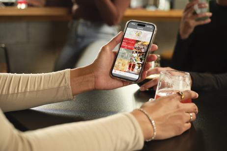 Group of friends using the Beer City Brewsader app at a local brewery.