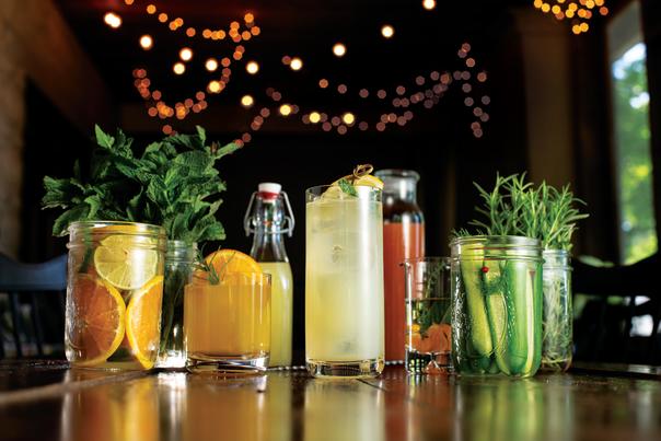 String lights in the background of colorful craft drinks.