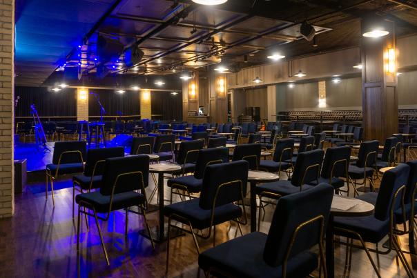 Empty chairs and tables neatly surrounding the Listening Room stage.