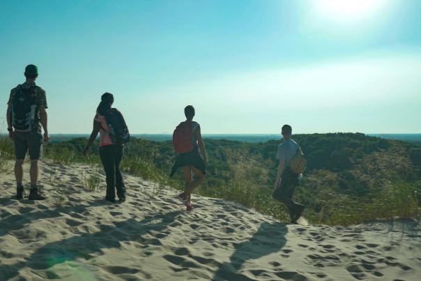 Hiking a trail in the PJ Hoffmaster State Park, which leads to a beach on Lake Michigan.
