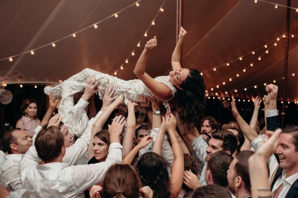 Crowd surfing reception bride