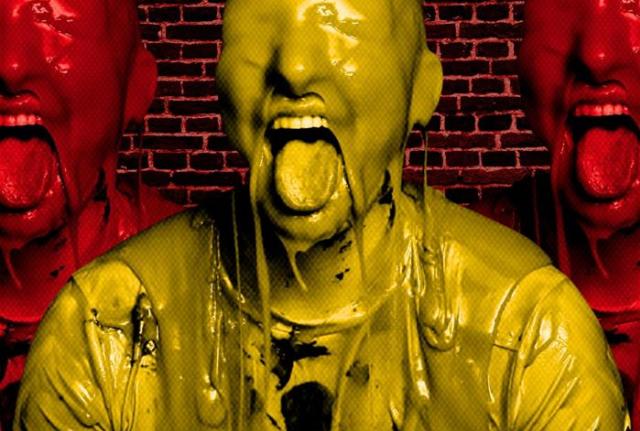 Image shows man covered in a liquid all over his head with his mouth open and tongue out.