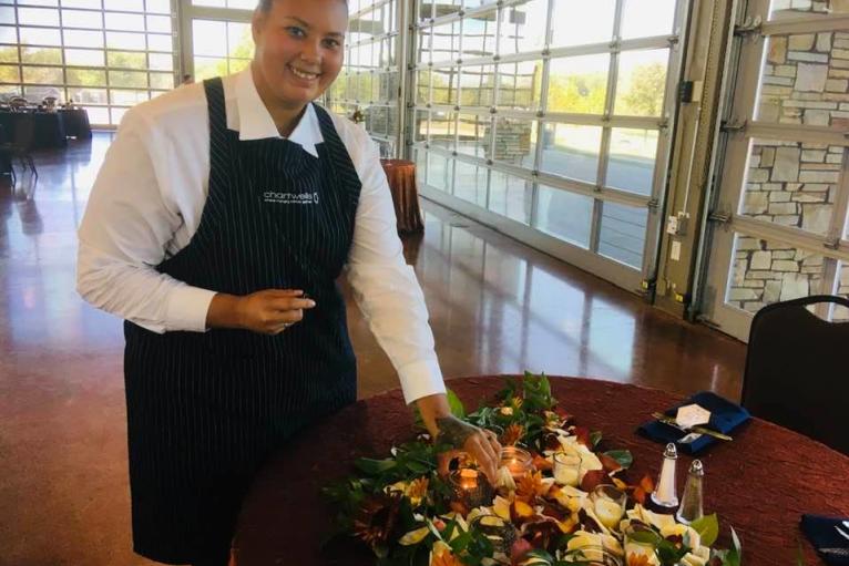 Catering attendant serving at a wedding.