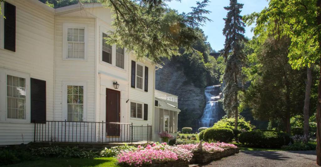 The Estate at Glenora Falls - Building Exterior with Waterfall