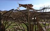 “Grasshopper” by Judd Weisburg, a sample of “Art in the Wild” now located over the entry gate to the Hudson Highlands Nature Museum’s new nature play area, Grasshopper Grove.