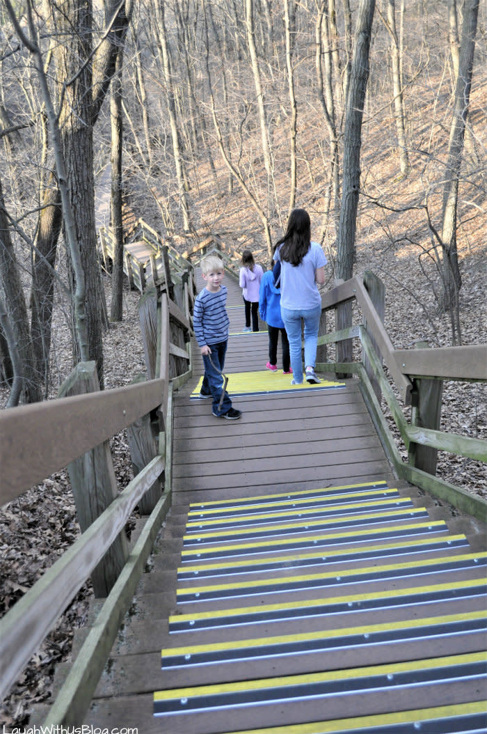 Children walking down the West Beach trail's wooden stairs