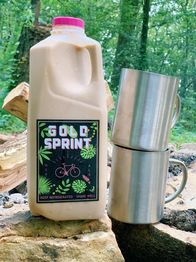 A half gallon jug of Gold Sprint Coffee with coffee mugs in Huntsville, AL