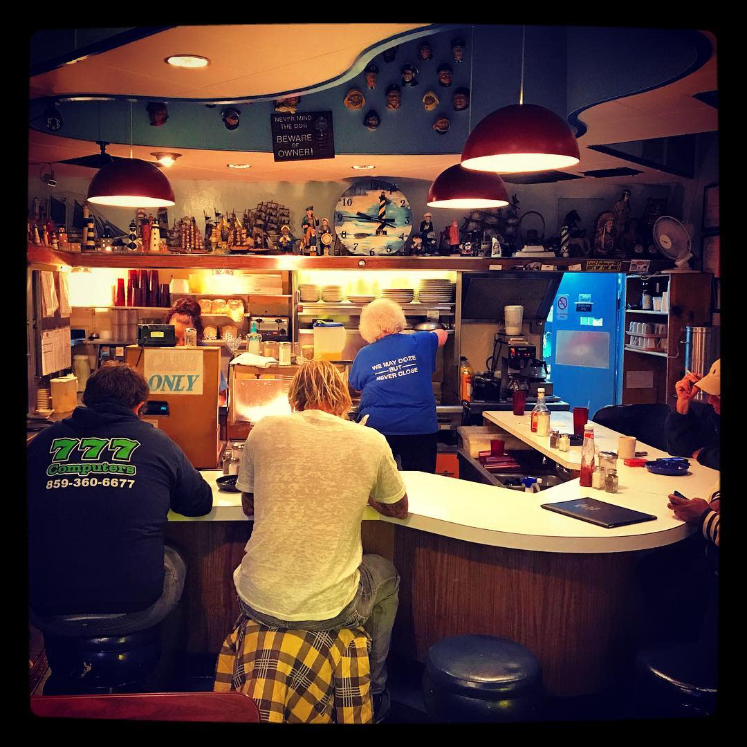 picture of two men sitting on stools in the anchor grill, a diner in covington kentucky