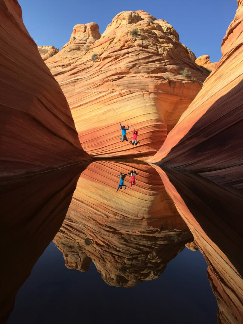 Reflection of The Wave and two people jumping
