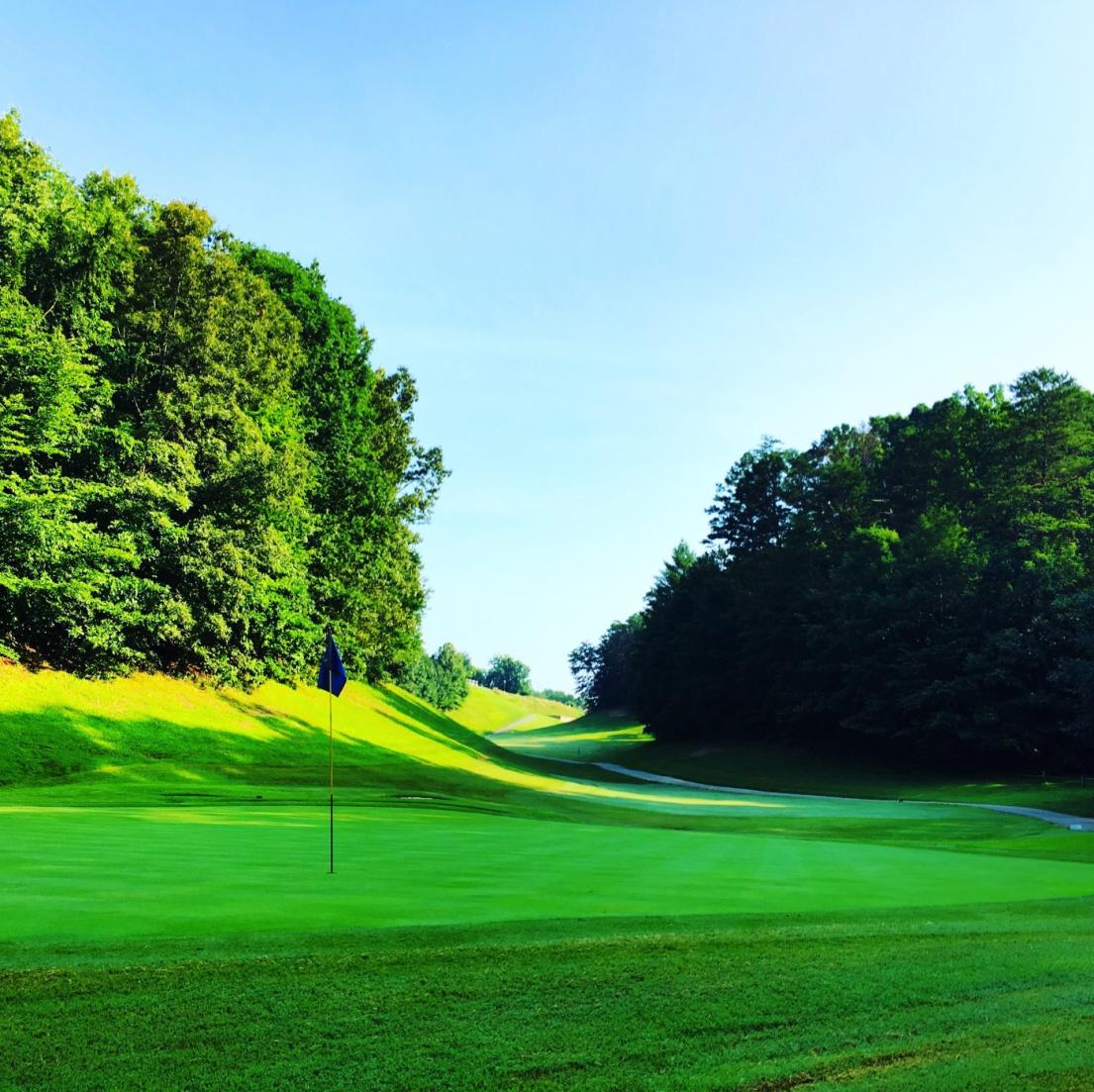 The well-manicured green grass invited players to put at the Gatlinburg Golf Course.