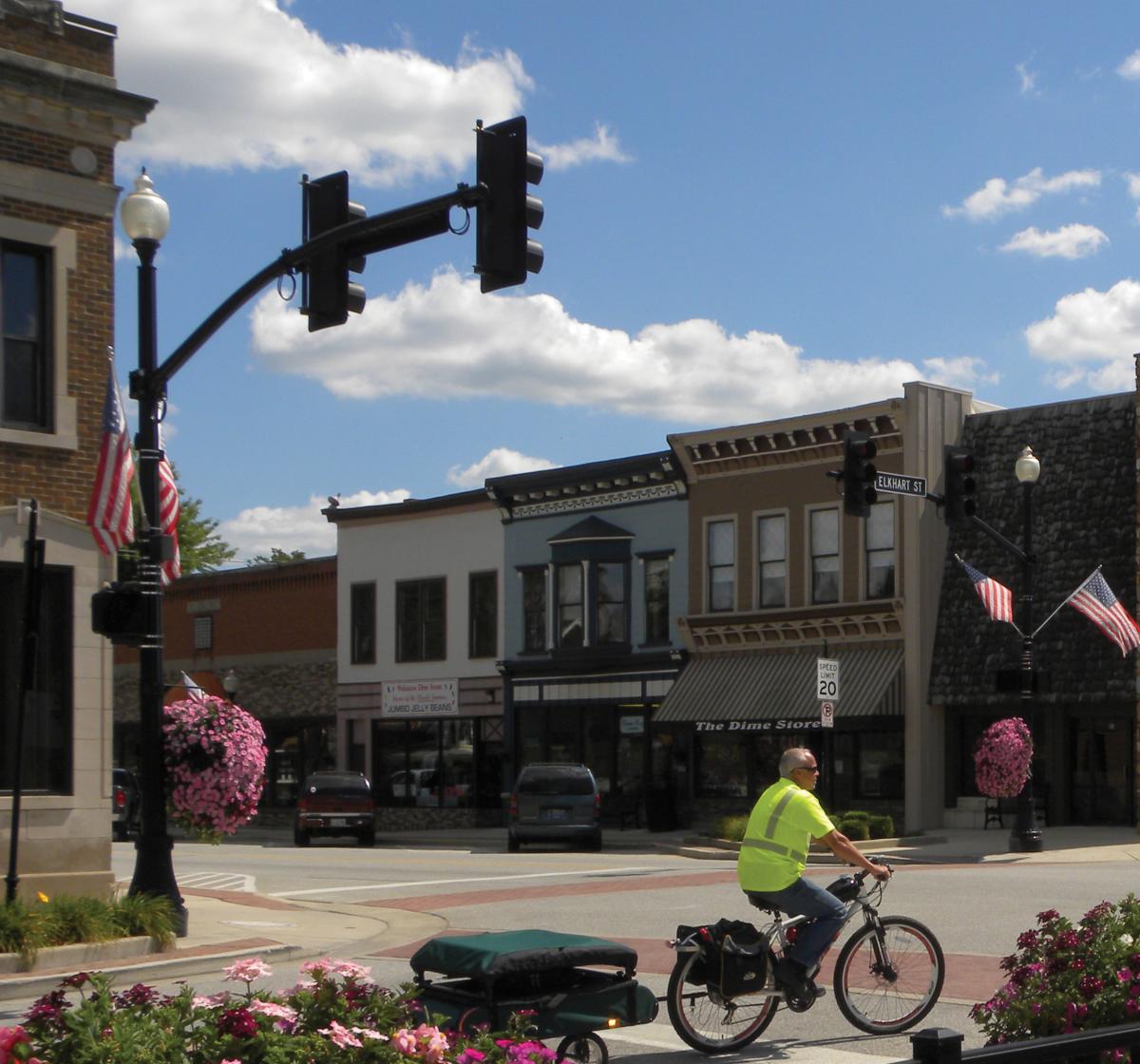 Man in a yellow shirt biking in Wakarusa, IN