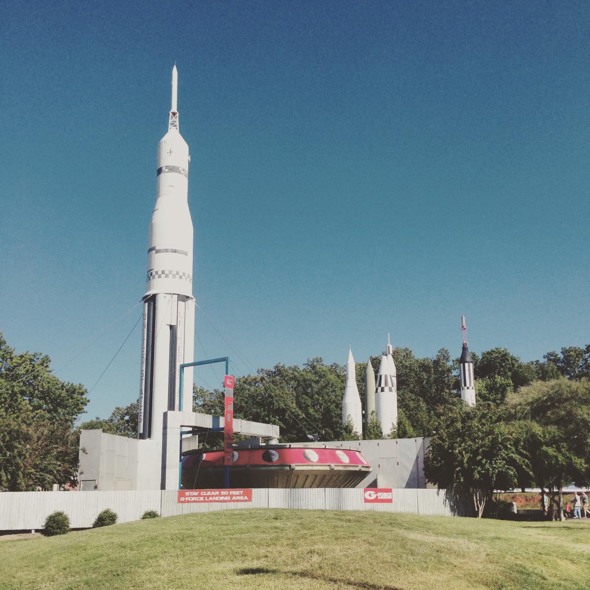 Rockets rise up behind the saucer-shaped U.S. Space and Rocket Center