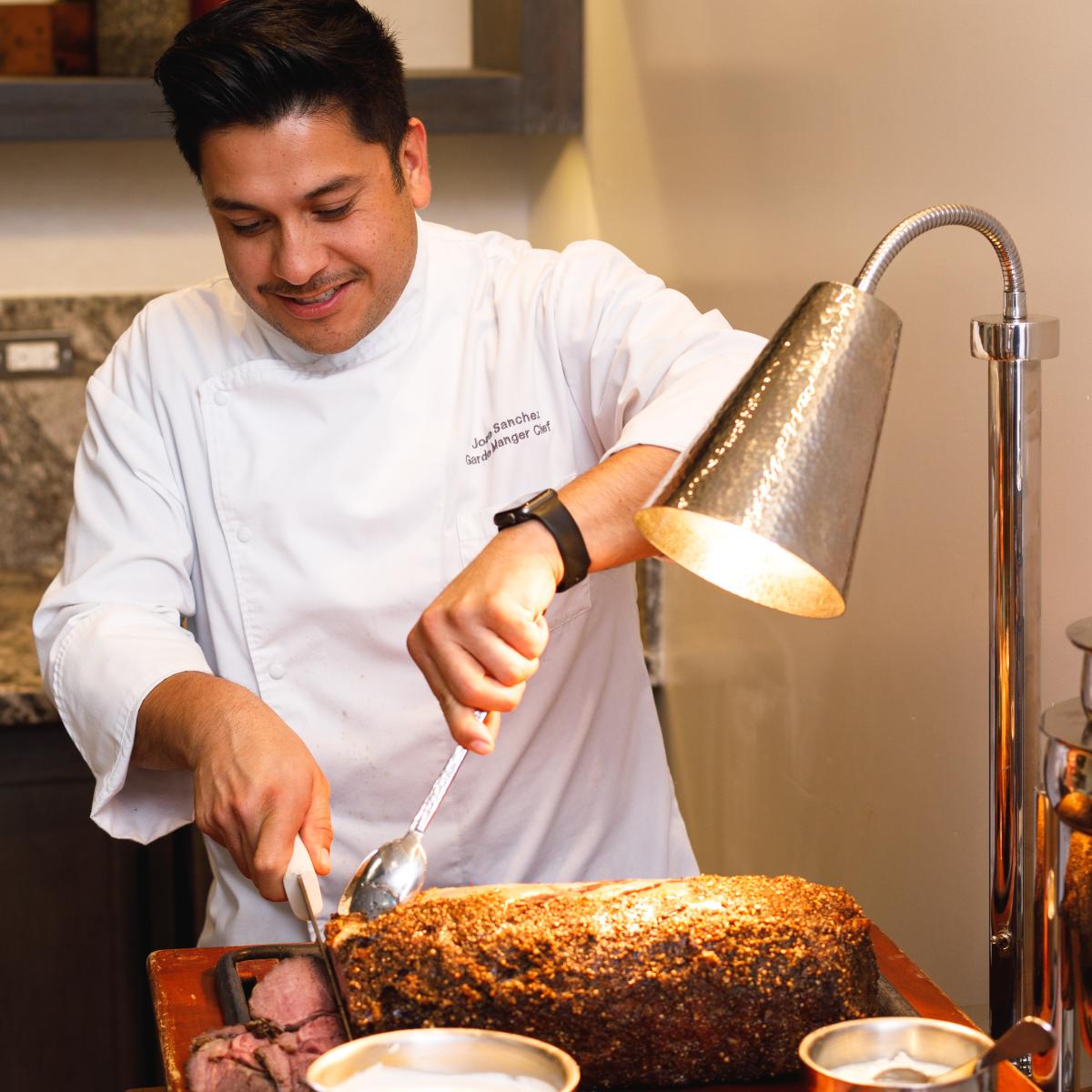 Chef slicing roast beef for Christmas Dinner at The Waterfront Beach Resort, a Hilton Hotel