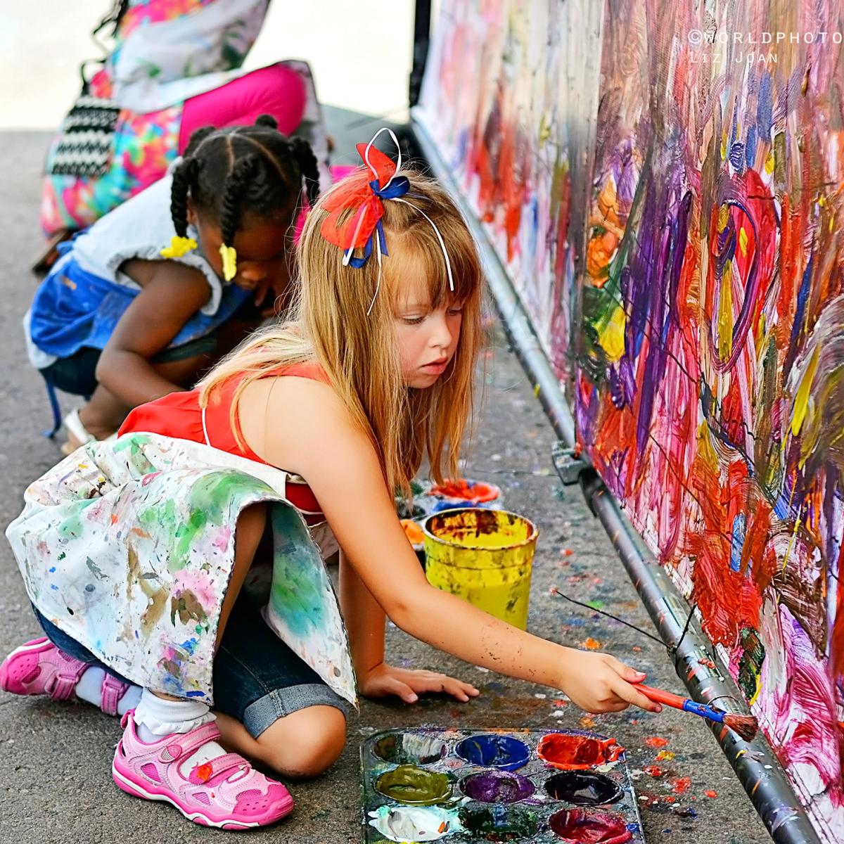 Little girls painting at the Cherry Creek Arts Festival