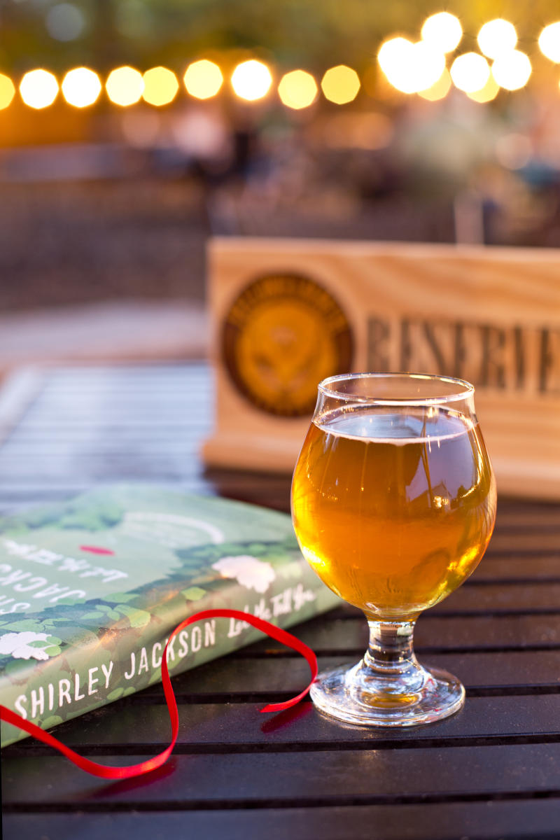 A glass of beer on a reserved table at Yellowhammer Brewing in Huntsville, AL