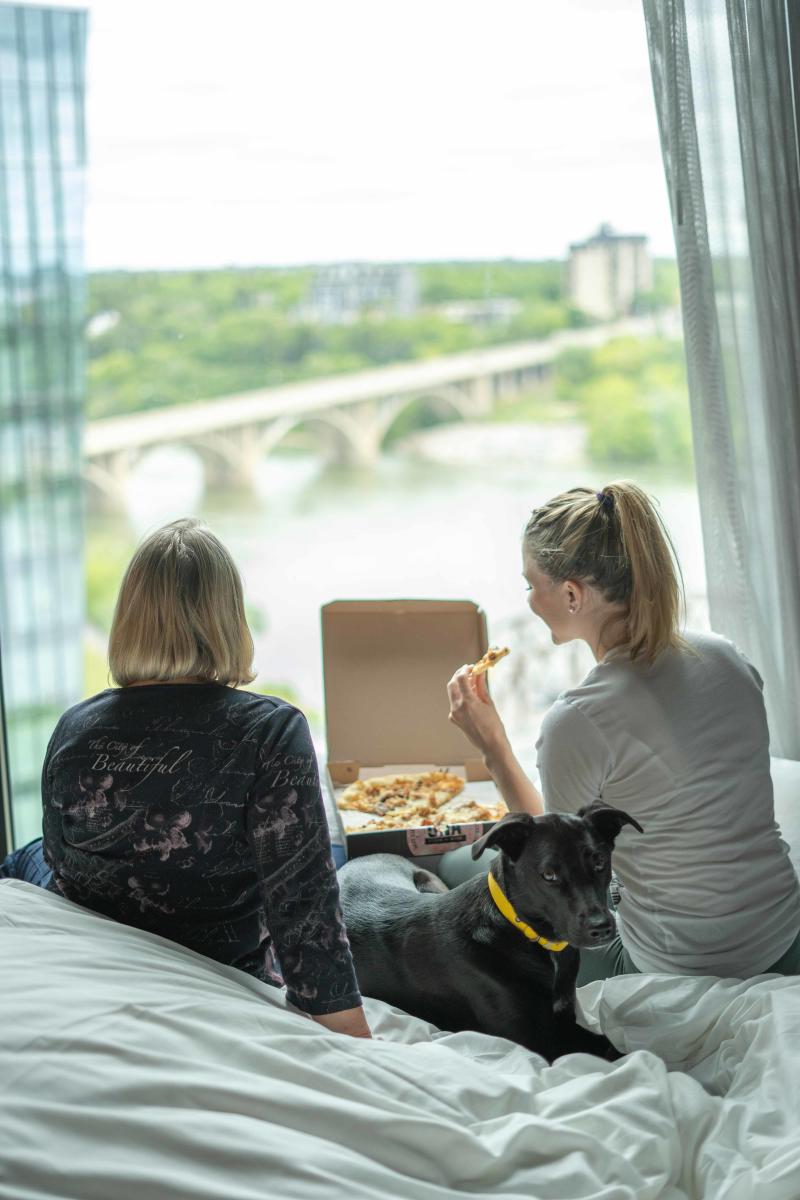 Two Women Eating Una Pizza in Saskatoon