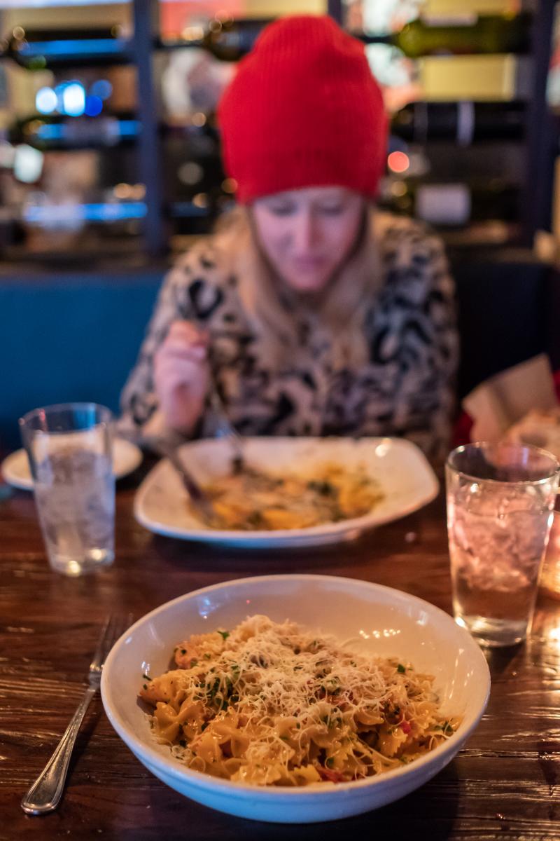 Patron enjoying food at Capone's Cucina in Huntington Beach