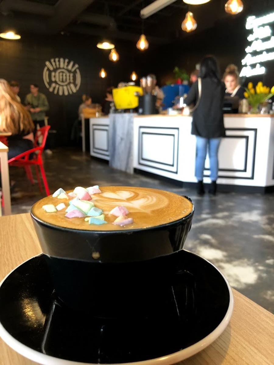 Rainbow marshmallows float in the foam of a fresh cup from Offbeat Coffee.