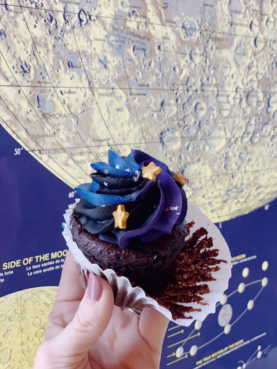 A visitor shows off their star-topped Vegan Mason Dixon Cupcake.