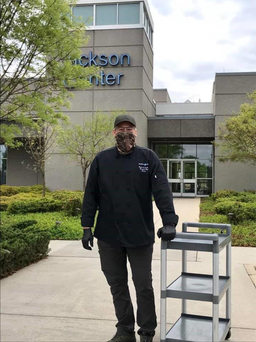 Man In Mask Infront Of Jackson Center