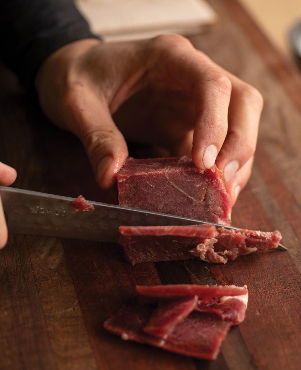 Ortiz preparing elk meat.