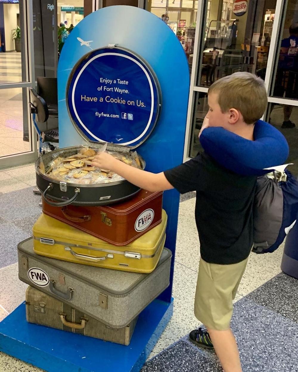 Child picking out a complimentary cookie at the Fort Wayne International Airport