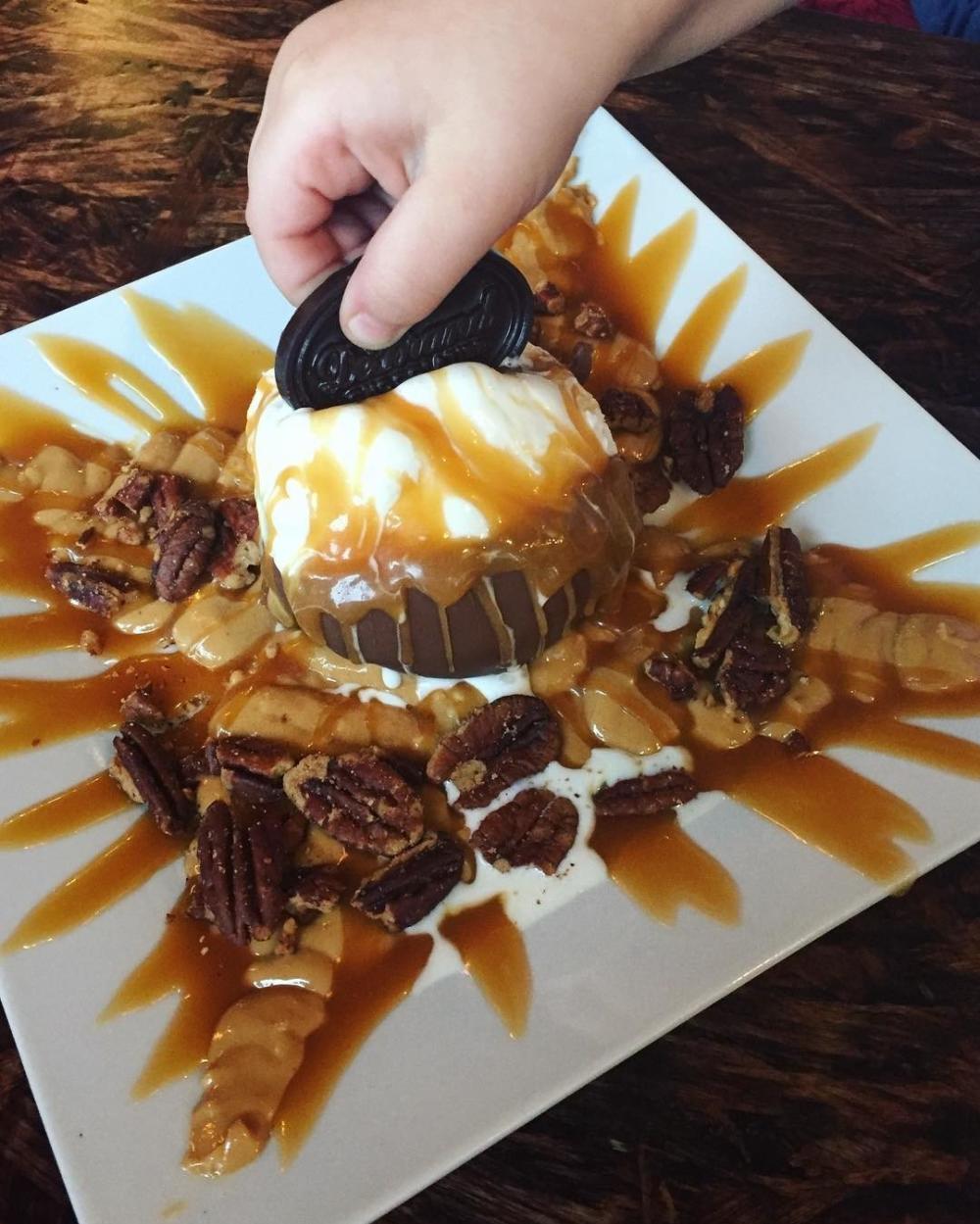 Hot caramel sundae with peanut butter and pecans at DeBrand Fine Chocolates