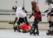 Mob Zombie (7), skating for the Oz Revolution team in white, steps over a downed opposing skater during the last renegade-style roller derby bout held in Oswego. Oz Roller Derby will bring renegade-style roller derby back to the Port City this Saturday at the Oswego YMCA Armory.